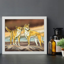Load image into Gallery viewer, Dingoes of Australia print on a desk. Australian animal art.
